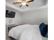 Inviting bedroom features a ceiling fan, mounted TV, desk area and is decorated in neutral tones at 10005 Sage Creek Dr, Ruskin, FL 33573