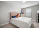 Comfortable bedroom featuring a decorative headboard and bedside table plus gray stuffed animals at 10005 Sage Creek Dr, Ruskin, FL 33573
