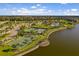 Aerial view of tennis and basketball courts with a pool and clubhouse nearby at 10005 Sage Creek Dr, Ruskin, FL 33573