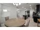 Bright dining area with a round table, chandelier, and seamless flow into the kitchen at 10005 Sage Creek Dr, Ruskin, FL 33573