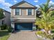 Charming two-story home with a blue garage door and well-maintained landscaping at 10005 Sage Creek Dr, Ruskin, FL 33573