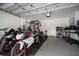 Garage featuring two motorcycles and a home gym setup with weightlifting equipment at 10005 Sage Creek Dr, Ruskin, FL 33573