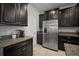 Beautiful kitchen with dark cabinets and granite countertops and stainless steel refrigerator at 10005 Sage Creek Dr, Ruskin, FL 33573