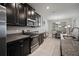 Modern kitchen with stainless steel appliances, granite countertops, and dark cabinetry at 10005 Sage Creek Dr, Ruskin, FL 33573