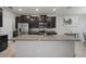 Modern kitchen featuring stainless steel appliances, granite countertops and dark brown cabinets at 10005 Sage Creek Dr, Ruskin, FL 33573