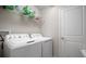 Laundry room featuring a side-by-side washer and dryer plus a shelf of cleaning supplies at 10005 Sage Creek Dr, Ruskin, FL 33573