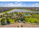 A high angle aerial view of a community center and resort style pool with lake views at 10005 Sage Creek Dr, Ruskin, FL 33573