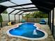 Swimming pool is surrounded by a screen enclosure, brick paver deck, water features, and lounge seating at 10005 Sage Creek Dr, Ruskin, FL 33573