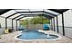 Enclosed in-ground kidney-shaped pool with water features and brick paver deck with lounge seating at 10005 Sage Creek Dr, Ruskin, FL 33573