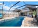 Relaxing screened-in pool with brick patio and water feature under a bright blue sky at 10005 Sage Creek Dr, Ruskin, FL 33573