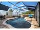 Stunning screened-in pool with surrounding brick pavers, a fountain, and stylish seating at 10005 Sage Creek Dr, Ruskin, FL 33573