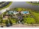 A high angle aerial view of a community center and resort style pool with lake views at 10005 Sage Creek Dr, Ruskin, FL 33573