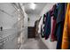 Well-organized walk-in closet with ample shelving and hanging space, with access to bathroom and shelves at 10005 Sage Creek Dr, Ruskin, FL 33573