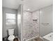 Stylish bathroom with mosaic tiled shower, marble look shower walls, and updated fixtures at 1002 Fruitland Ave, Bradenton, FL 34207