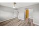 Clean bedroom with wood-look flooring, a ceiling fan and neutral paint at 1002 Fruitland Ave, Bradenton, FL 34207