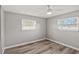 Bright bedroom featuring wood-look floors, and natural light from two windows at 1002 Fruitland Ave, Bradenton, FL 34207