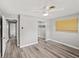 Neutral bedroom with wood-look flooring, a ceiling fan and a walk-in closet at 1002 Fruitland Ave, Bradenton, FL 34207