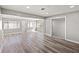 Bright living room featuring wood-look flooring, many windows with blinds, and a closet at 1002 Fruitland Ave, Bradenton, FL 34207