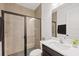 Well-lit bathroom with a glass-enclosed shower, modern vanity, and neutral tile at 1043 Davis Heather Cir, Seffner, FL 33584