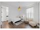 A bright bedroom showcases natural lighting, neutral decor, and wood-look tile flooring at 1043 Davis Heather Cir, Seffner, FL 33584