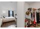 A well-organized walk-in closet complements the bedroom with dark curtains and wood-style floors at 1043 Davis Heather Cir, Seffner, FL 33584