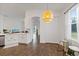 Bright dining area with decorative pendant light and seamless transition to kitchen at 1043 Davis Heather Cir, Seffner, FL 33584