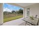 Covered patio features a table and view of the backyard and blue sky at 1043 Davis Heather Cir, Seffner, FL 33584