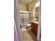 Bathroom featuring tile flooring, wooden vanity, and shower with neutral gray shower curtain at 11248 Mollymawk Ct, New Port Richey, FL 34654