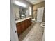 Bathroom featuring double sinks, granite countertops, and decorative lighting at 11248 Mollymawk Ct, New Port Richey, FL 34654