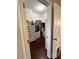 Walk-in closet featuring built-in shelving and hardwood flooring at 11248 Mollymawk Ct, New Port Richey, FL 34654