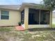 Exterior of the home featuring a screened-in patio and view of the surrounding landscape at 11248 Mollymawk Ct, New Port Richey, FL 34654