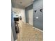 Hallway leading to a living space with tile flooring and blue colored walls at 11248 Mollymawk Ct, New Port Richey, FL 34654