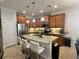 Well lit kitchen featuring an island with bar seating and stainless steel appliances at 11248 Mollymawk Ct, New Port Richey, FL 34654