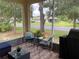 Enjoy this cozy screened-in patio with a table and chairs overlooking the landscaped backyard at 11248 Mollymawk Ct, New Port Richey, FL 34654