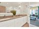 Bright bathroom featuring double sink vanity with granite countertops and views of the living room and balcony at 1238 E Kennedy Blvd # 702, Tampa, FL 33602