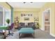 Inviting bedroom space with sunny yellow walls, comfortable seating, and carpeted floors at 1238 E Kennedy Blvd # 702, Tampa, FL 33602