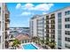 View of the complex pool featuring lounge chairs, palm trees, and a complex exterior view at 1238 E Kennedy Blvd # 702, Tampa, FL 33602
