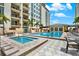 Beautiful community pool and spa area with lounge seating and lush landscaping at 1238 E Kennedy Blvd # 702, Tampa, FL 33602