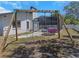 Backyard showcasing swing set with view of the screened-in pool area at 14007 Middleton Way, Tampa, FL 33624