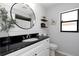 Well-lit bathroom featuring a vessel sink with a black countertop and decorative shelving at 14007 Middleton Way, Tampa, FL 33624
