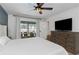 Airy bedroom with a ceiling fan and sliding glass doors, offering a view of the outdoor seating area at 14007 Middleton Way, Tampa, FL 33624