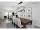 Open concept dining room and living area with modern decor, neutral colors, and wood flooring at 14007 Middleton Way, Tampa, FL 33624