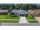 Aerial front view of a single-story home showcasing a well-maintained lawn and landscaping at 14007 Middleton Way, Tampa, FL 33624