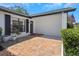 Charming front entrance features brick accents, lush greenery, and a welcoming entrance door at 14007 Middleton Way, Tampa, FL 33624