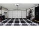 Spacious garage features black and white tiled flooring and ample room for storage and parking at 14007 Middleton Way, Tampa, FL 33624