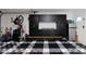Garage featuring checkerboard flooring, built-in storage cabinets, and mini refrigerator at 14007 Middleton Way, Tampa, FL 33624