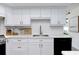 Contemporary kitchen featuring white cabinets, quartz countertops, and stainless steel appliances at 14007 Middleton Way, Tampa, FL 33624