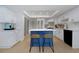 Bright kitchen featuring white cabinets, stainless steel appliances, blue island with seating and modern fixtures at 14007 Middleton Way, Tampa, FL 33624