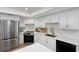 Well-lit kitchen featuring white cabinets, stainless steel appliances, and quartz countertops at 14007 Middleton Way, Tampa, FL 33624