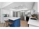 Bright kitchen with white cabinets, stainless steel refrigerator, and a blue island with white countertop at 14007 Middleton Way, Tampa, FL 33624